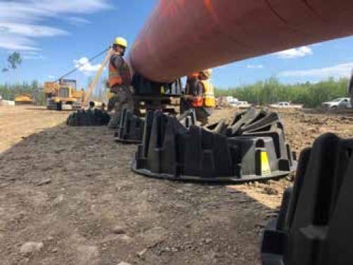 Figure 1. PipePillo® SPP being tied to 1067 mm (42 in.) OD pipe prior to installation outside of the trench on North Montney Mainline project in Alberta, Canada.