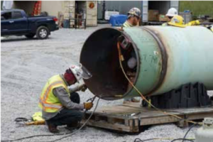 Figure 4. PipePillos supporting pipe while welder backwelds a fitting on the Mountain Valley Pipeline project in West Virginia, US.