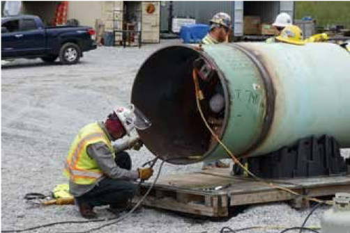 Figure 4. PipePillos supporting pipe while welder backwelds a fitting on the Mountain Valley Pipeline project in West Virginia, US.