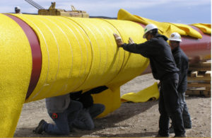 yellow stranded rockshield being installed on pipe