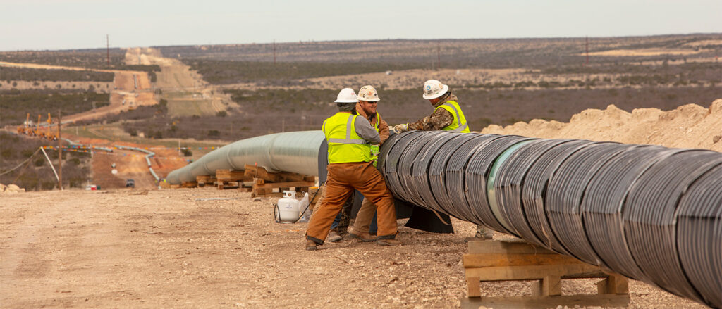 Rockguard HD being installed with filament tape on pipeline