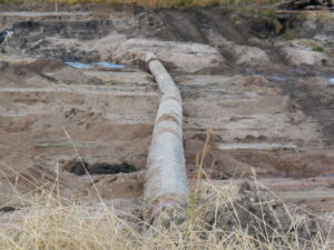 Kink in concrete-coated pipe caused by rushing flood waters